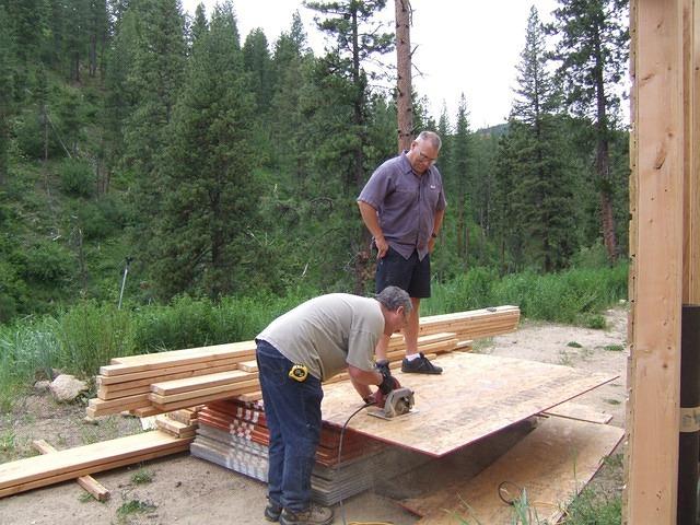 Paul gets the hard job of holding the OSB steady while Curtis cuts it to size.