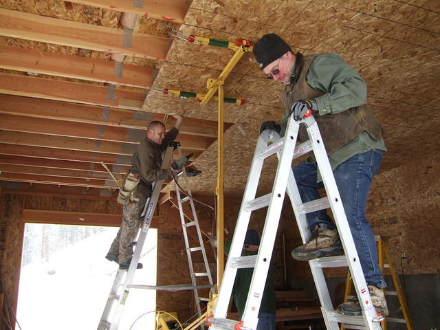 Curtis and Chris putting osb on the ceiling.