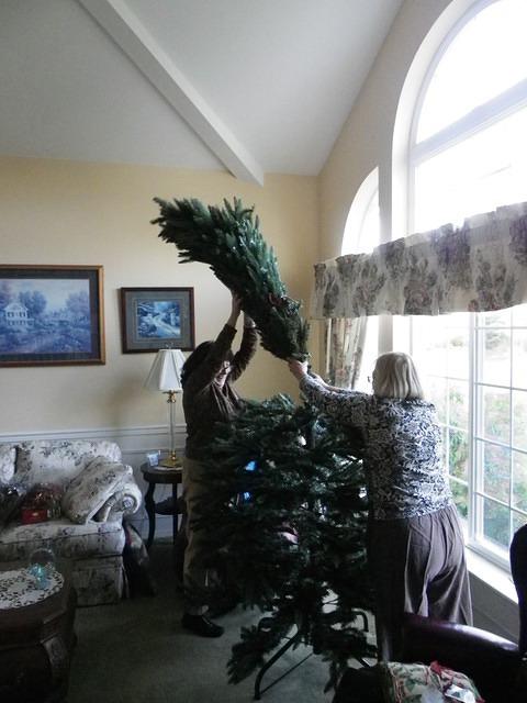 Judy and Pat working just as hard putting up the tree.