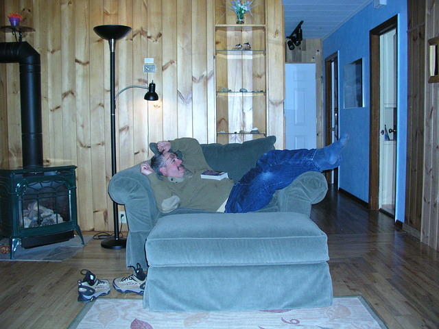 Curtis is lounging by the gas fireplace which is the sole source of heat for the rooms. The two bedrooms and bath are down the h
