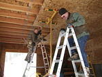 Curtis and Chris putting osb on the ceiling.