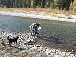 Curtis is getting water from the Boise River; Paul is attempting to toss him in.