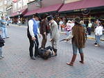 A western show was put on in the town's main street. The guy on the ground was caught and put on trial.