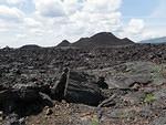 Craters of the Moon park. There is a burnt piece of wood in front of the lava it looks like.
