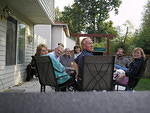 Oakie, Peg. Tom, Jane, Judy, Kent and Pat holding Eddie, all sitting on Pat's deck by Seattle, WA.